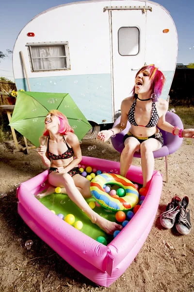 Women in a play pool playing with bubbles — Stock Photo, Image