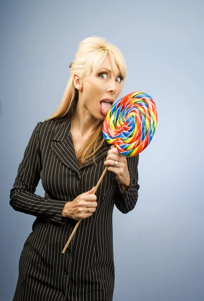 Woman licking a lollipop — Stock Photo, Image