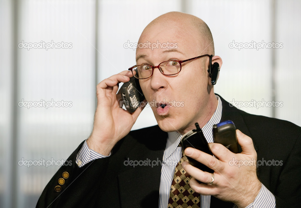 Businessman with multiple cell phones
