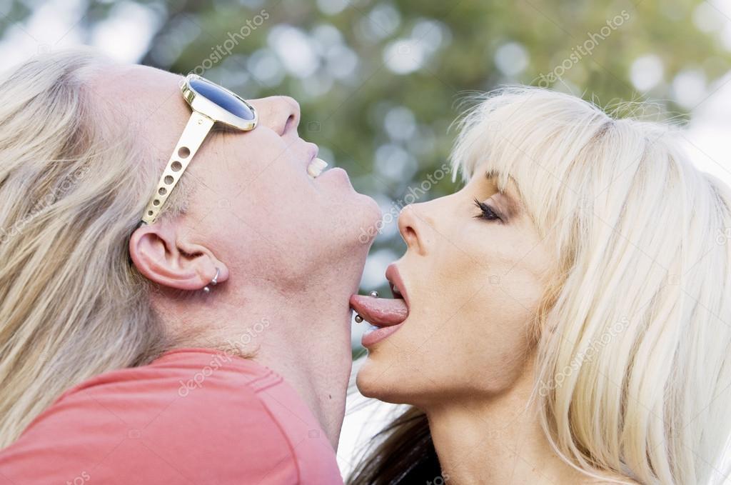 Download - Woman with big eyes licking a man on the neck - Stock Image. 