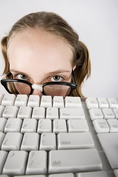 Joven chica nerd con un teclado — Foto de Stock