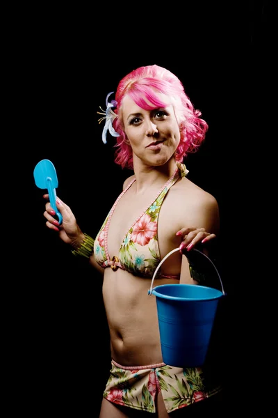 Woman in a bikini on black with pail and shovel — Stock Photo, Image