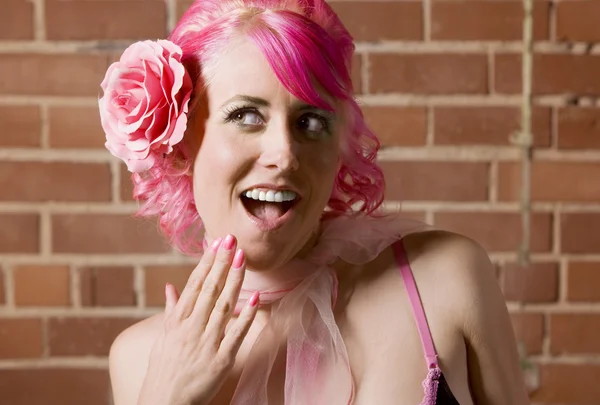 Surprised woman with flower in her hair — Stock Photo, Image