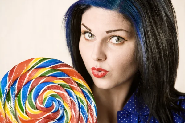 Pretty woman with a lollipop — Stock Photo, Image