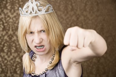 Pretty young girl with a tiara throws a punch clipart