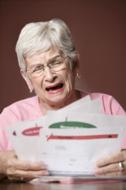 Senior woman with bills and notices clipart