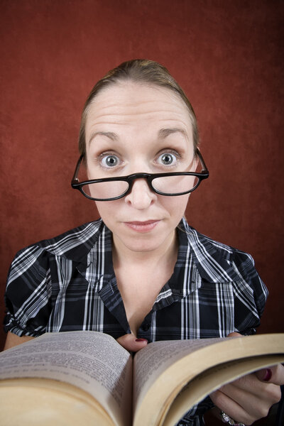 Woman with big eyes reading a book
