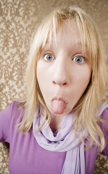 Young girl sticking out her tongue