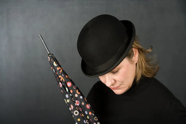 Woman in a bowler hat with umbrella — Stock Photo, Image