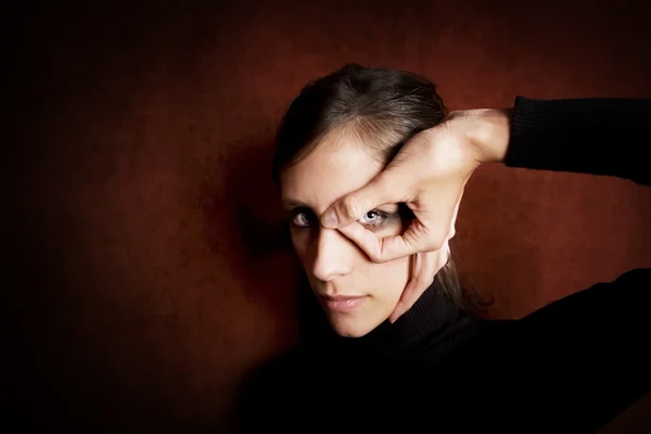 Model with dark makeup circling her eye — Stock Photo, Image