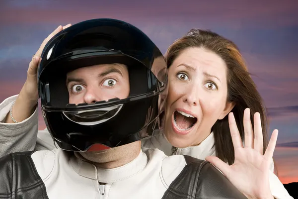 Man and fearful woman on a motorcycle — Stock Photo, Image