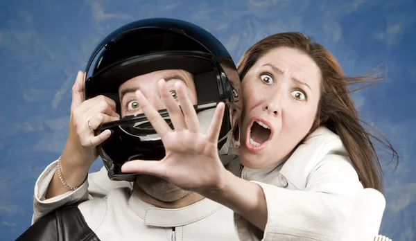 Man and fearful woman on a motorcycle — Stock Photo, Image