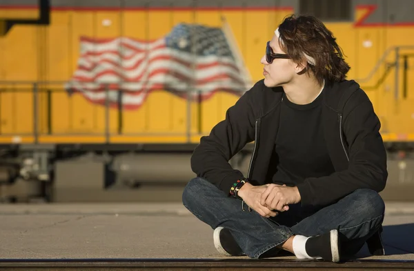 Boy with glasses in front of boxcar — Stock Photo, Image