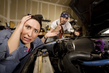 Frustrated woman with incompetent mechanic in background clipart