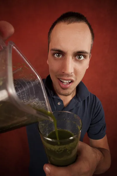 Young man with unappetizing health shake — Stock Photo, Image