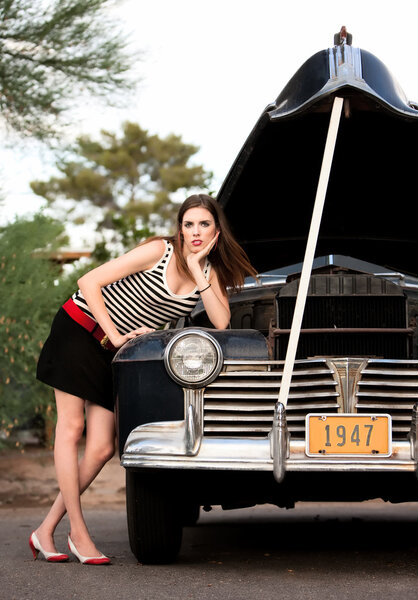 Girl in stripes with vintage car