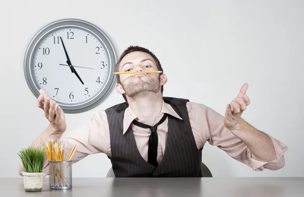 Bored young businessman balancing a pencil — Stock Photo, Image