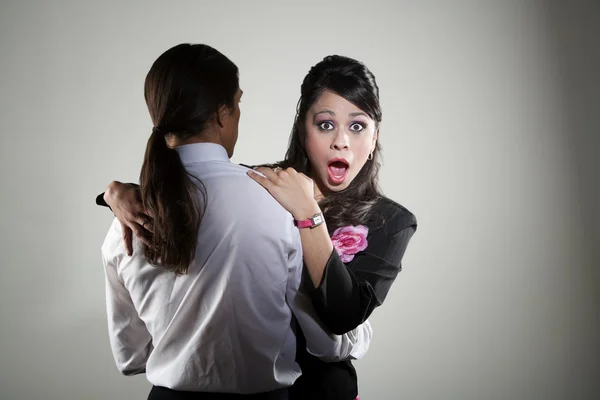 Mixed race professional man embracing Hispanic woman — Stock Photo, Image