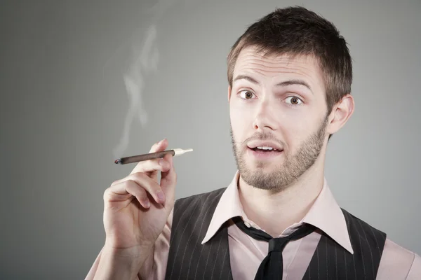 Happy young man with small cigar — Stock Photo, Image