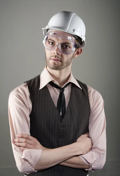 Young man in hard hat and safety goggles — Stock Photo, Image