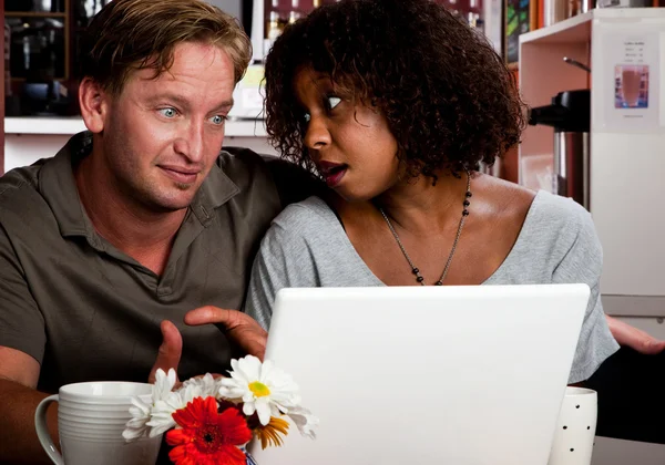 Mixed race couple in coffee house with laptop computer — Stock Photo, Image