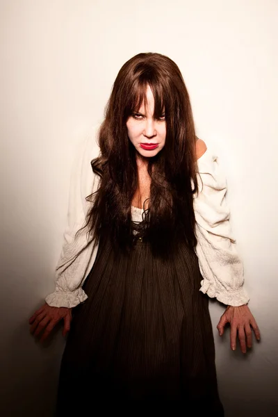 Village witch with red eyes in a corner — Stock Photo, Image