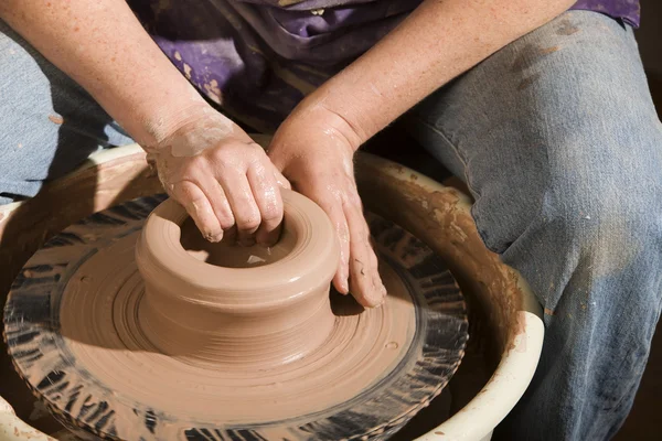 Hands forming clay on wheel — Stock Photo, Image