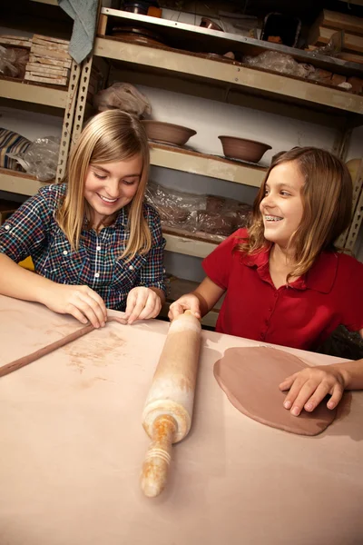 Cute young girls in a clay studio — Stock Photo, Image