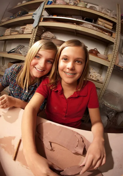 Cute young girls in a clay studio — Stock Photo, Image