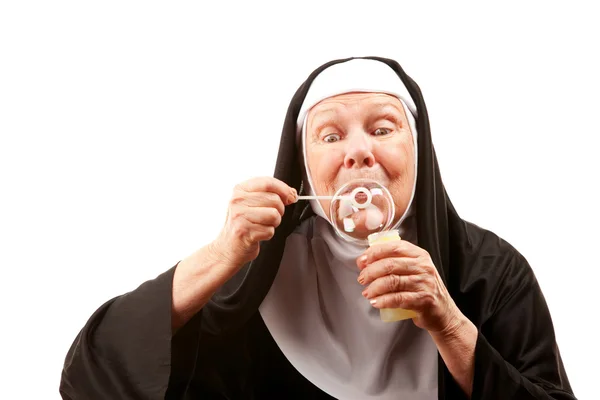 Funny nun with blowing bubbles — Stock Photo, Image