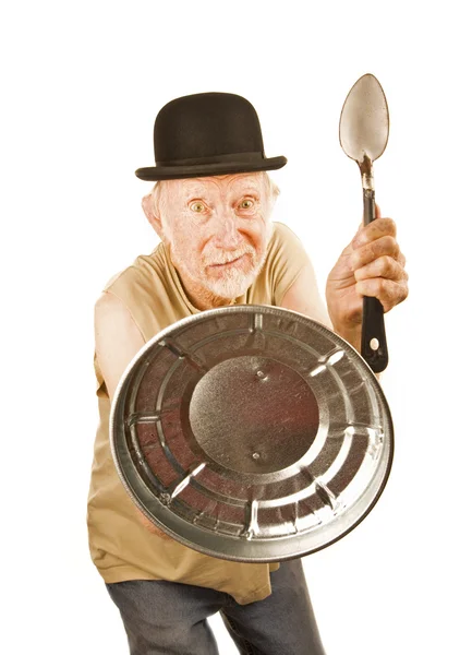 Senior defending himself with spoon and can lid — Stock Photo, Image