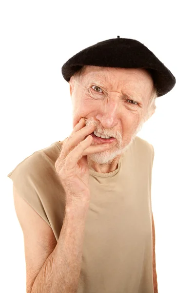 Verward senior man in baret — Stockfoto