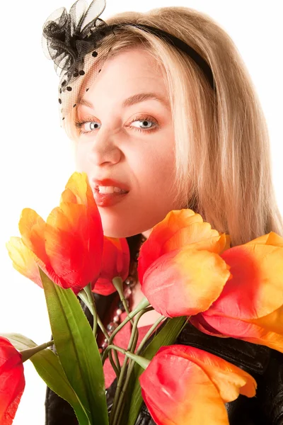 Pretty young blonde woman with plastic flowers — Stock Photo, Image