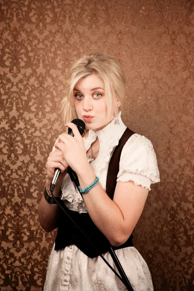 Pretty young singer or comedian with microphone — Stock Photo, Image