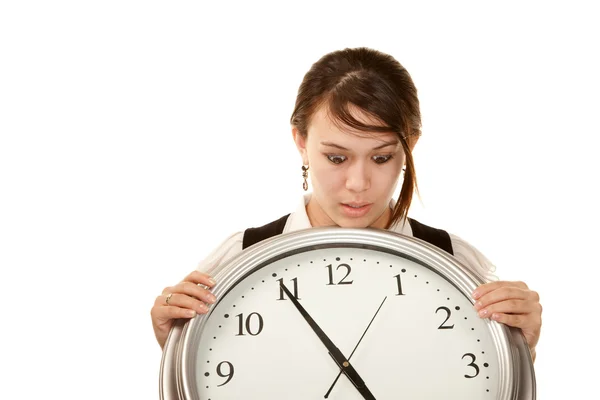 Mujer en el trabajo sosteniendo reloj grande — Foto de Stock