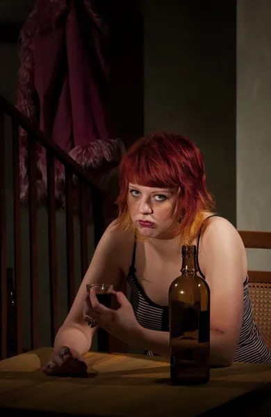 Young woman with near enpty bottle of wine — Stock Photo, Image