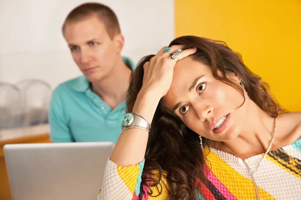 Woman in the foreground with a frustrated expression — Stock Photo, Image