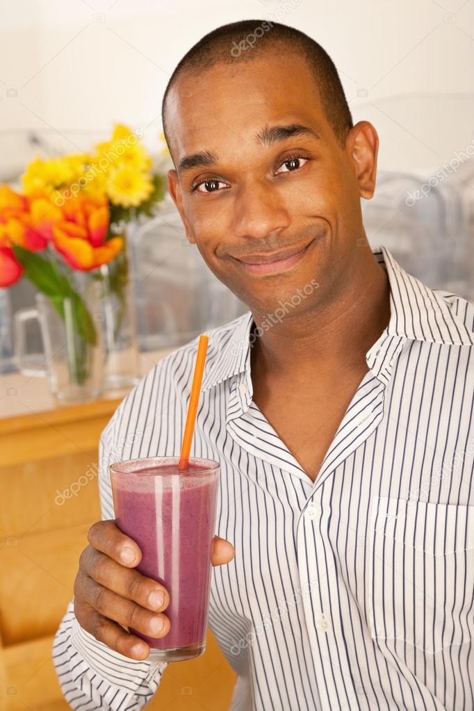 Man is holding a smoothie
