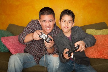 Hispanic Man and Boy Playing Video game clipart