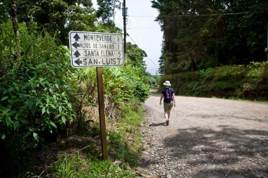 Hiker near sign in Santa Elena Costa Rica clipart