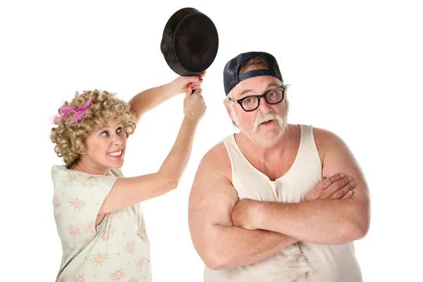 Woman swinging frying pan at husband — Stock Photo, Image