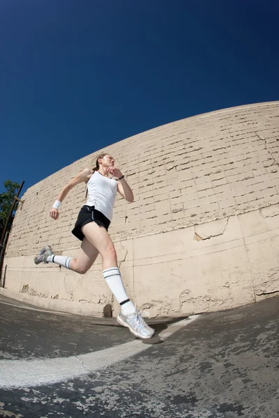 Mujer corre hacia la línea de meta . — Foto de Stock