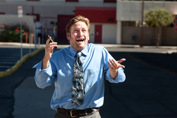 Good-looking guy frustrated with cell phone. — Stock Photo, Image