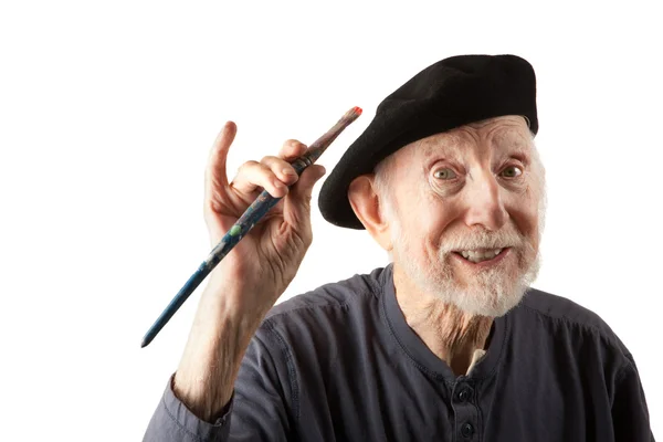 Senior artist with beret and brushes — Stock Photo, Image