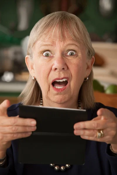 Senior woman with checkbook — Stock Photo, Image