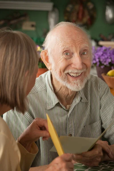 Senior man with greeting card — Stock Photo, Image