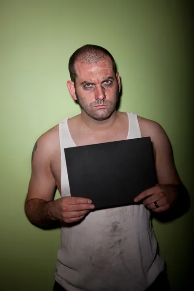 Angry man in mugshot — Stockfoto