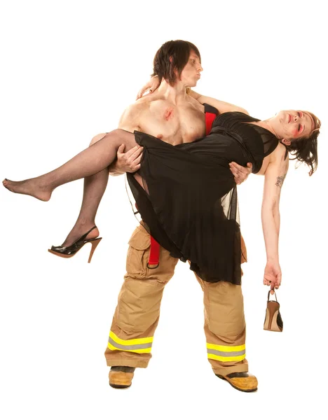 Sexy fireman rescuing pretty woman — Stock Photo, Image