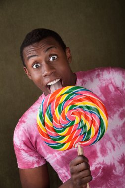 Man Licks Giant Candy Sucker clipart