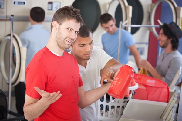 Confused Young Man in Laundromat — Stock Photo, Image